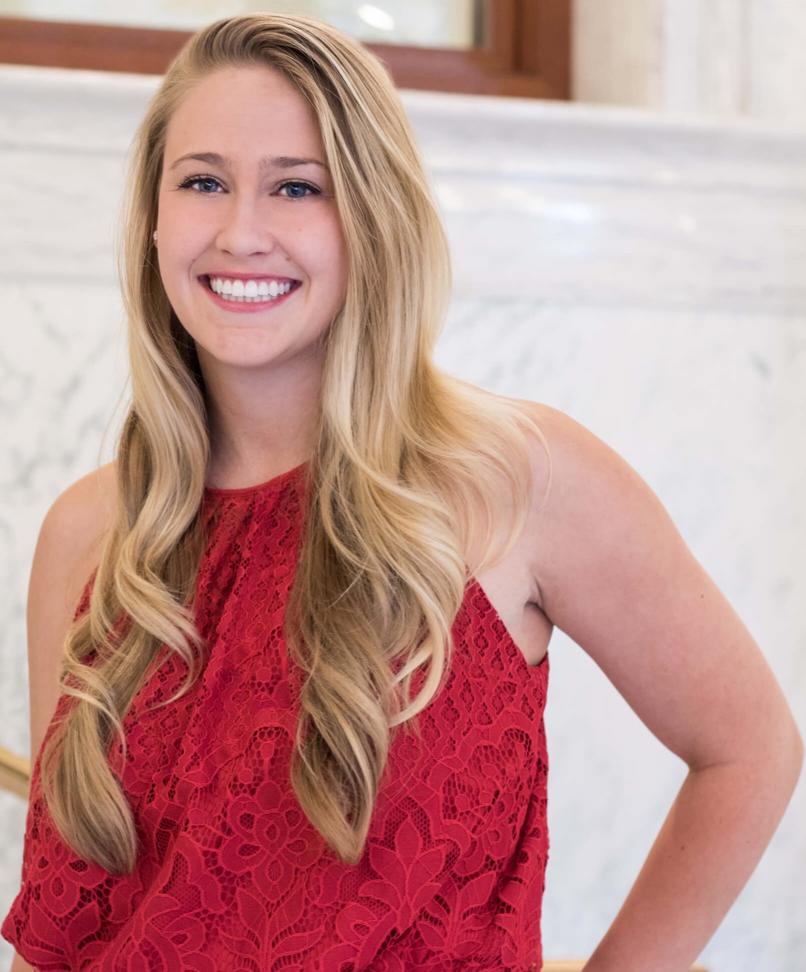 Taylor headshot standing in red dress